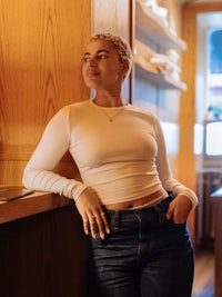 a woman leaning against a wall in a restaurant